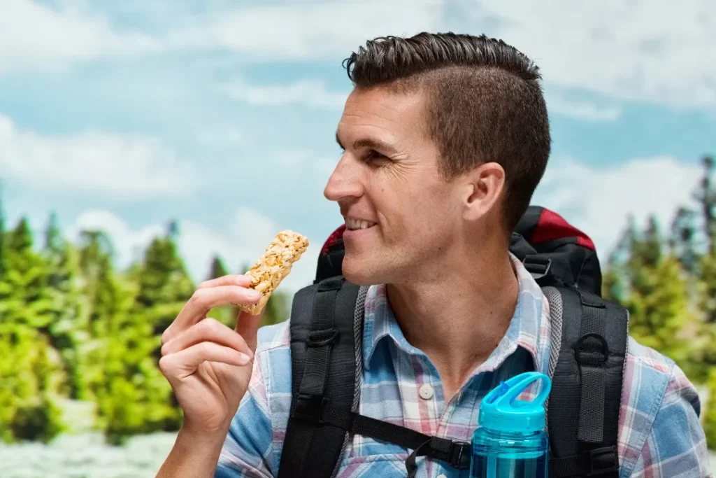 Man eating a protein bar to stay active and energetic. 