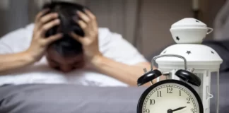 young man with sleeping disorder unable to sleep at mid night.