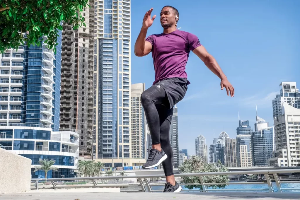 young energetic man doing exercise in the city.