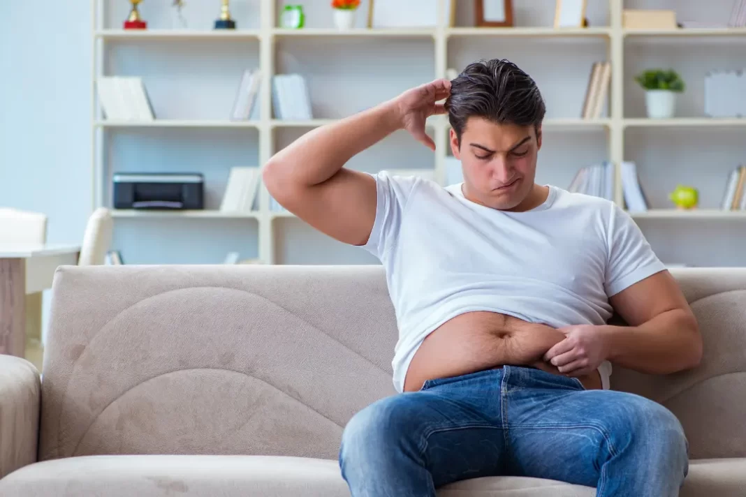 Man depressed with his belly fat.