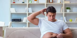 Man depressed with his belly fat.