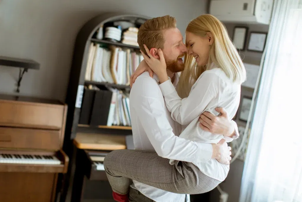 Beautiful young couple cuddling and kissing.