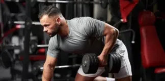 Bodybuilder bench pressing dumbbell with one arm.
