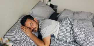 young man sleeping on bed