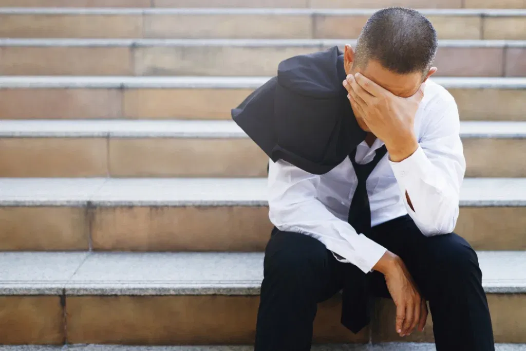 stress man sitting on the stairs