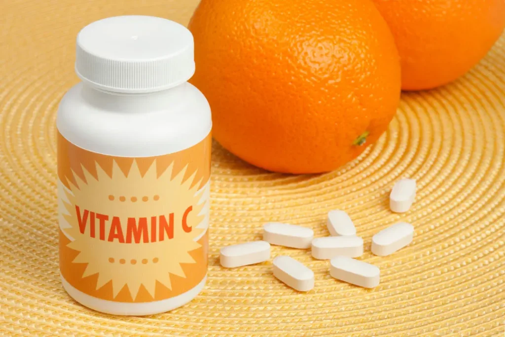 vitamin c supplements  with orange on the background
