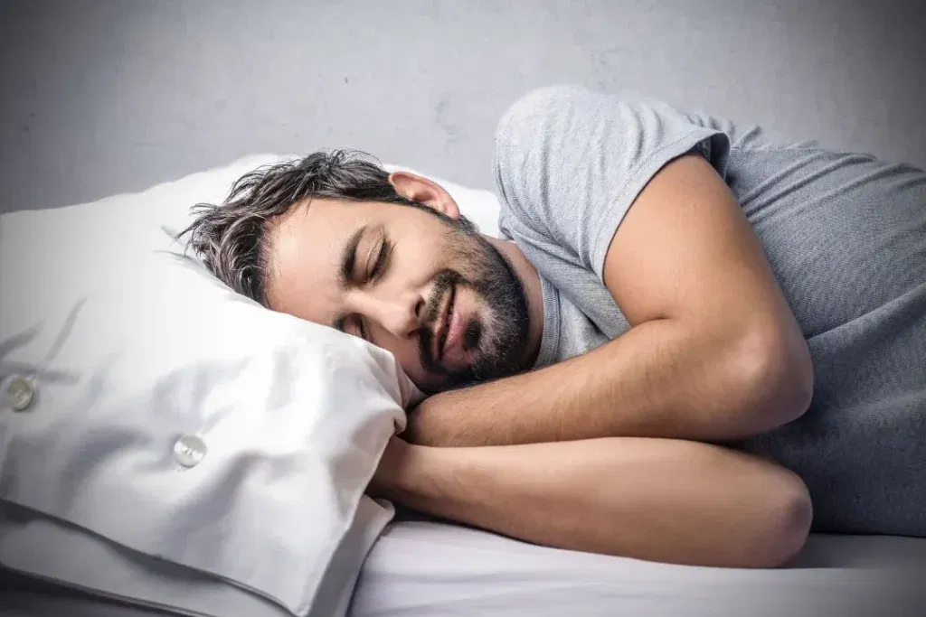 young men sleeping on a bed