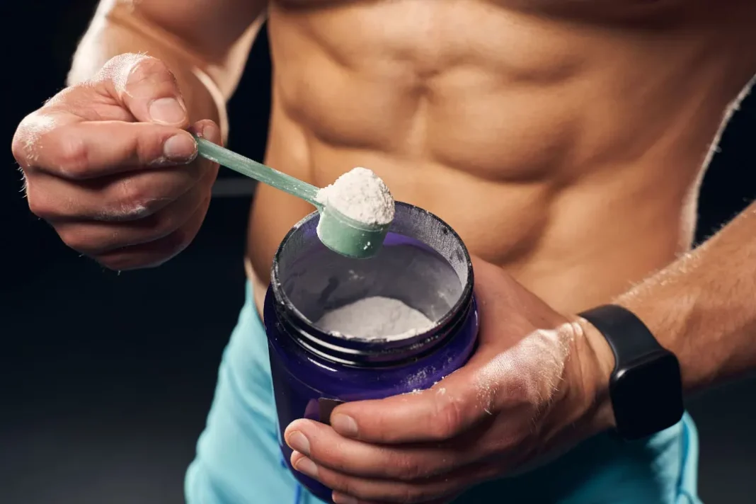 man holding a container with protein powder
