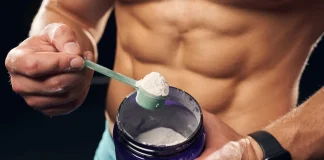 Paleo Protein Powder vs Nuzest Clean Lean Protein man holding a container with protein powder